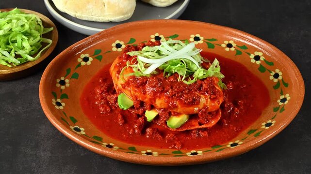 Typical Mexican food, pambazo with chorizo, lettuce, avocado and ground beef