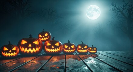 A group of carved jack-o-lanterns sitting on a wooden deck at night