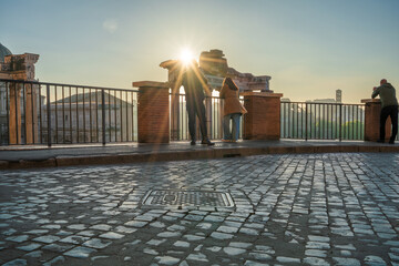 Tourist couple visit Temple of Saturn at Roman forum ruins onsunrise in Rome. Italy © Pawel Pajor