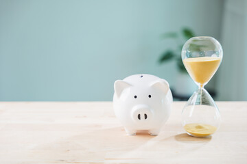 White piggy bank money invest dividend income interest fund pig save strategy on table near...