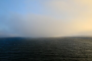 Spooky fog rolling in on the ocean surface