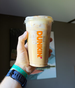 Iced Coffee from Dunkin in Hand Indoors