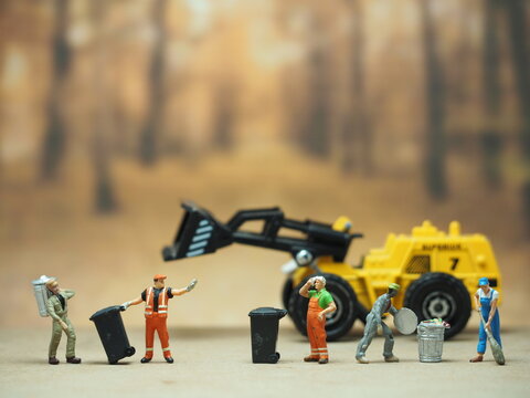 Mini toy at table with blurred background. Cleaning crew concept design.