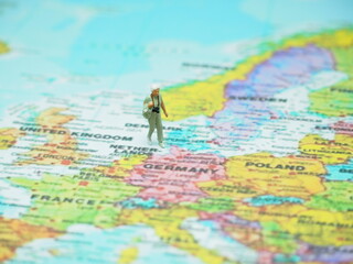 Naklejka premium Miniature toy with blurred map as a background.