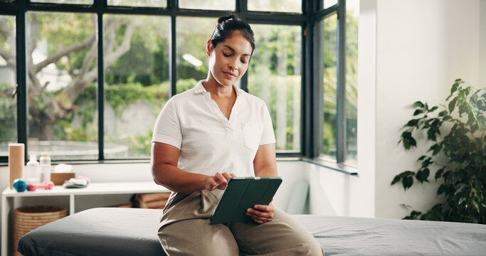 Woman, physiotherapist and schedule with tablet in room for online booking or appointment. Female person, therapist and reading with technology for checklist, agenda or planning in recovery clinic
