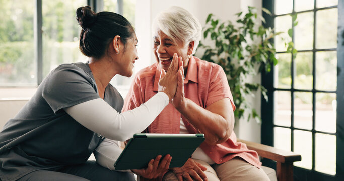 Healthcare, high five or tablet with nurse and old woman in home for celebration of test results. App, medical or success with caregiver and senior patient in assisted living facility for motivation
