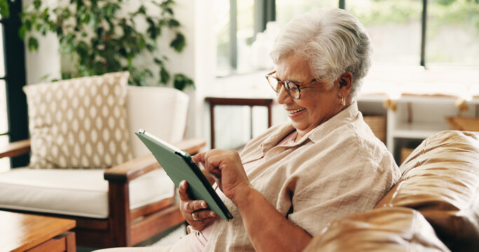 Reading, tablet or senior woman on couch, word game app or online brain teaser for retirement wellness. Smile, crossword puzzle or old person with tech in home, play memory activity or entertainment