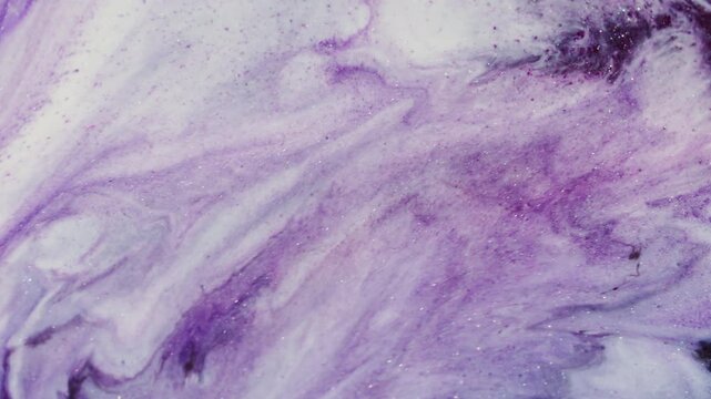 Acrylic glitter. Paint blend. Shimmering marble white purple liquid abstract texture. Color particles flow defocused wave background.
