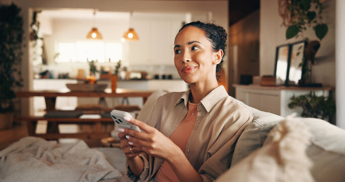 Phone, thinking and typing with woman on sofa in living room of home for break, chilling or me time. App, ideas and text message with happy person in apartment for browsing or mobile communication