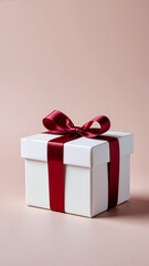 Obraz premium White Gift Box with Red Ribbon on Beige