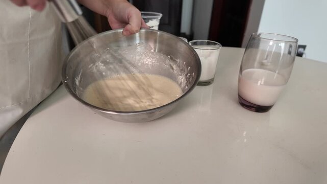 Woman added the ingredients to the batter and whipped the mixture