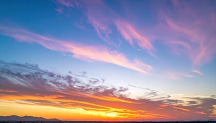 Fototapeta premium Vibrant sunset paints the sky with streaks of pink, orange and blue