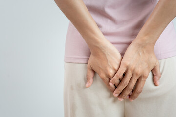 Girl hand holding bottom because having abdominal pain and hemorrhoids, No sit health care,...