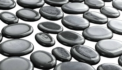 Close-up of smooth, glossy, dark gray pebbles arranged in a random pattern
