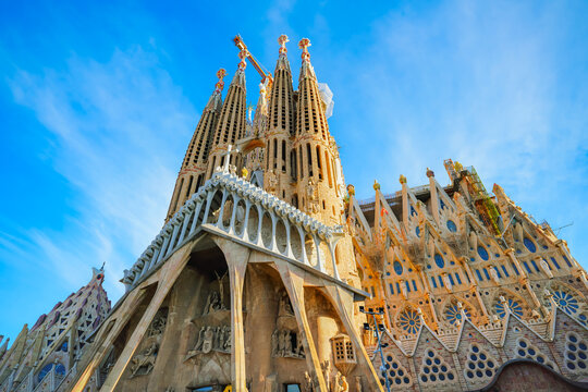 View of the unfinished Sagrada Familia on a sunny day in Barcelona, Spain. Sagrada Familia is a famous landmark symbolizing Barcelona&rsquo;s cultural, religious, and architectural heritage.