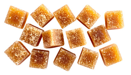 Isolated overhead view of scattered, textured, golden-brown, cubed confectioneries on black