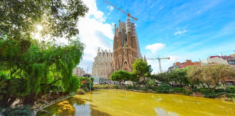 View of the unfinished Sagrada Familia on a sunny day in Barcelona, Spain. Sagrada Familia is a famous landmark symbolizing Barcelona’s cultural, religious, and architectural heritage. © Javen