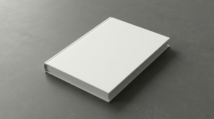 Fototapeta premium Blank white book on gray concrete background with soft shadow. mock up, copy space