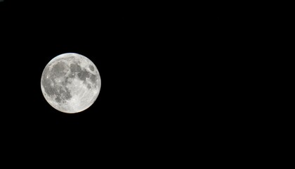 Obraz premium Full moon shining brightly in dark night sky capturing lunar surface details and craters