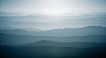 Fototapeta premium Layers of misty mountains at sunrise or sunset serene landscape view