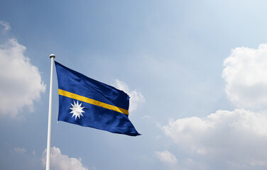 Nauru national flag waving in sky.