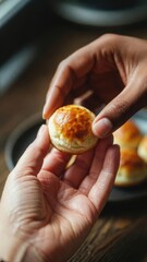 Holding small golden bun close up