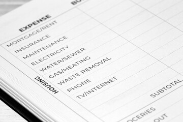 Fototapeta premium Household budget book with blank housing expense page background. Personal household finance concept.