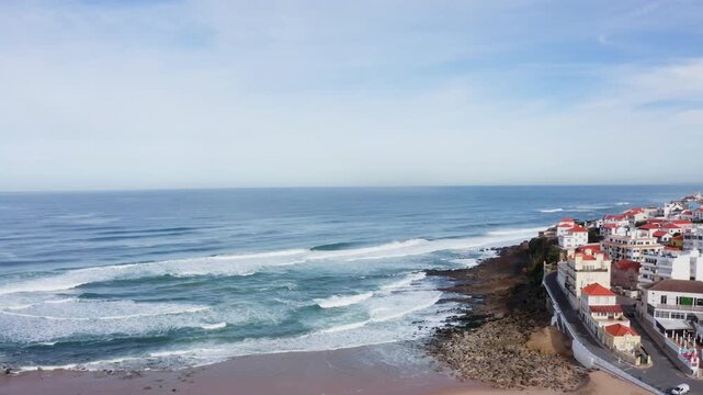 Beautiful Atlantic ocean Apple beach coastal surf with foamy waves. Flying drone 4K video capturing early morning landscape at Praia das Macas, Portugal.