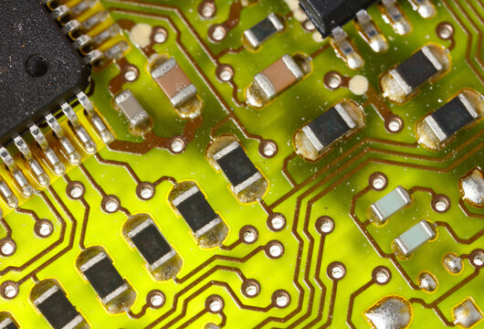Close-up of a green electronic computer board with microchips