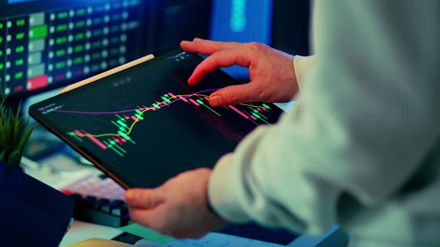 Cryptocurrency market analysis tablet trading chart. Investor hand navigating digital candlestick graph with trend lines across touchscreen display, volatile crypto exchange data visualization