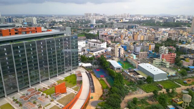 Aerial view of a modern glass office building and electronic plant with solar panels in Electronic city, Bengaluru, India