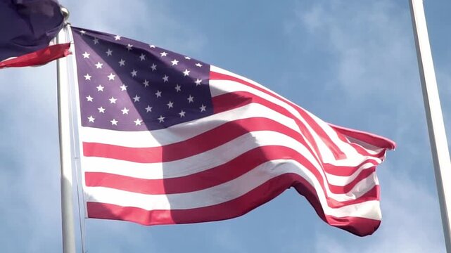American flag waving on blue sky. United States flag. Flag in wind.. USA national symbol. Freedom and democracy. Independence day. Stars and stripes. Waving USA flag. 