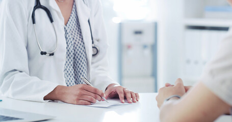 Doctor, hands and paperwork in hospital, appointment and explaining test results to patient or talk. Clinic, medical professional and consultation for diagnosis, people and healthcare with documents © peopleimages.com