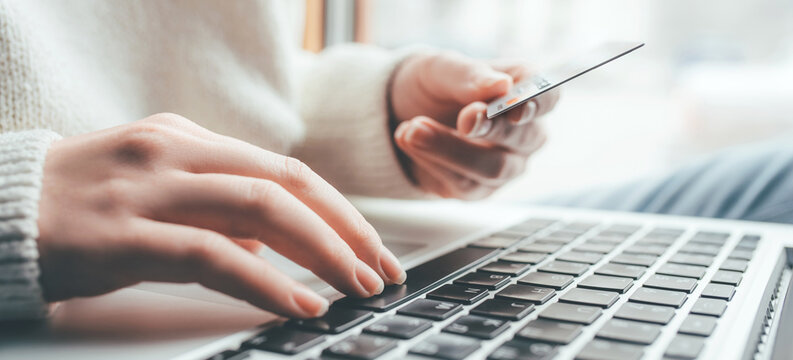 A young woman makes an online payment for a purchase.
