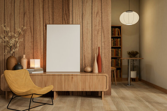 White frame on wooden table and yellow fabric chair on parquet floor with round lamp in room corner.