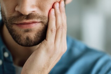 Fototapeta premium Suffering patient with severe toothache in clinic