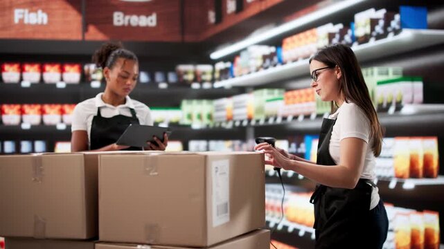 Employee Checking Inventory Shipment In Supermarket