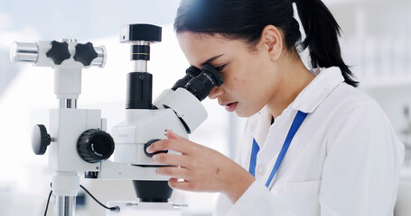 Woman, microscope and medical research at laboratory for particles, bacteria or sample analysis for...