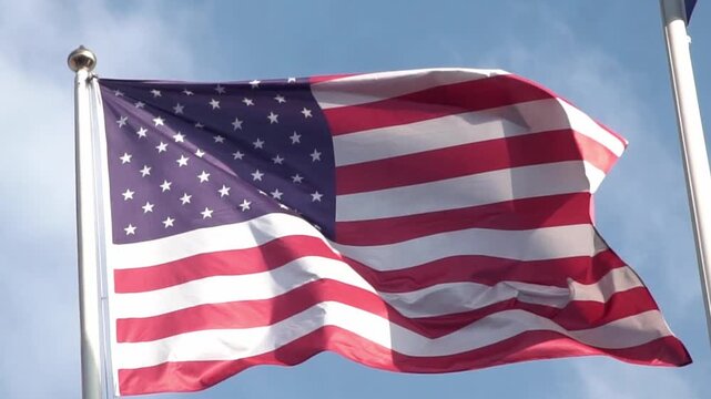 American flag waving on blue sky. United States flag. Flag in wind.. USA national symbol. Freedom and democracy. Independence day. Stars and stripes. Waving USA flag. 