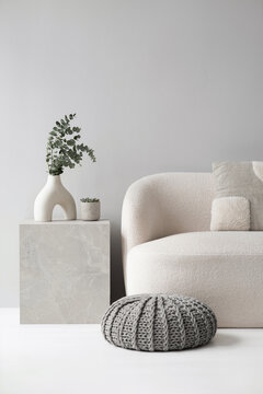 Modern scandinavian style interior with sofa and trendy vase, Home staging and minimalism concept. Minimal Scandi interior. Empty white wall background. 