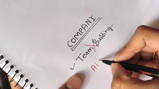 Close up video of entrepreneur crossing out Team Building and writing AI Automation with tick mark in notebook under company planning section. Concept showing shift from traditional team hiring to AI.