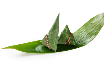 Two traditional zongzi sticky rice dumplings wrapped in bamboo leaves on white background