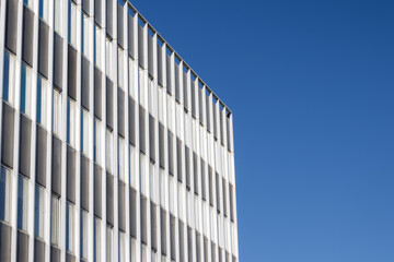 Fototapeta premium Modern building facade featuring geometric pattern against sky