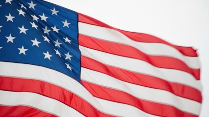 American flags waving in the wind against a blue sky with sunlight shining through, symbolizing patriotism and freedom from a low angle viewpoint on a sunny day outside.