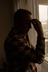 Man with headache, depression, sadness and loneliness at home