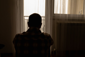 Man with headache, depression, sadness and loneliness at home