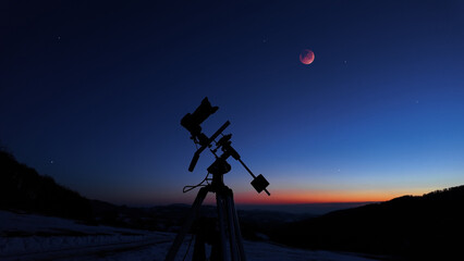 Amateur astrophotography equipment with camera, tripod star-tracker for photographing stars, planets and Moon.