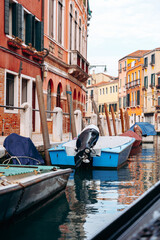 Fototapeta premium Boats rest in a quiet canal in a historic city on a clear sunny day