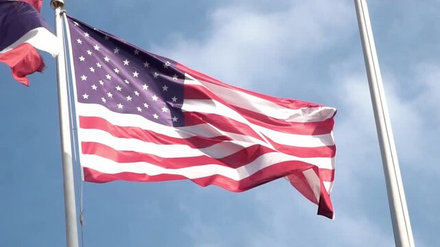 American flag waving on blue sky. United States flag. Flag in wind.. USA national symbol. Freedom and democracy. Independence day. Stars and stripes. Waving USA flag. 