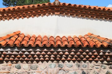 Traditional Ottoman Architecture Detail with Red Clay Tiled Sawtooth Cornice and Stone Wall